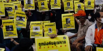 Protesters at the 18 July 2020 protest at the Democracy Monument holding missing person posters with images of victims of enforced disappearance.