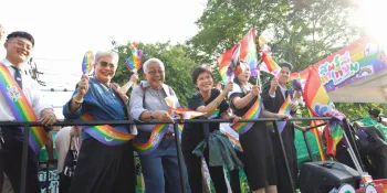 Activists and members of the bill's drafting committee waving rainbow Pride flags during the caravan celebrating the bill's passing.