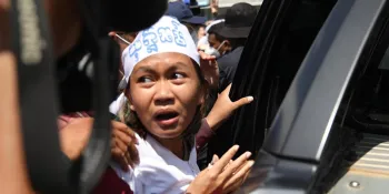 Mother Nature activist Phuon Keoraksmey being dragged into a car by the police after she was convicted on 2 July. (Photo from the Cambodian League for the Promotion and Defense of Human Rights - LICADHO)