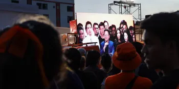 Move Forward Party supporters watching a live broadcast of party leader Chaithawat Tulathon's statement after the party was dissolved.