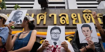 A protester (center) standing in front of the Criminal Court on 8 July 2025 holding a picture of Anon Nampa (Photo by Ginger Cat)