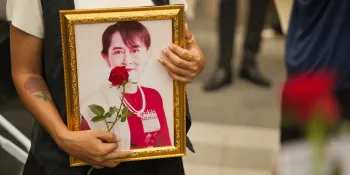 (Cover) A migrant worker from Myanmar holding a framed photo of Aung San Suu Kyi, detained former State Counsellor of Myanmar, at the Labour Day event in Bangkok on 1 May 2024. (Photo by Nathaphob Sungkate)